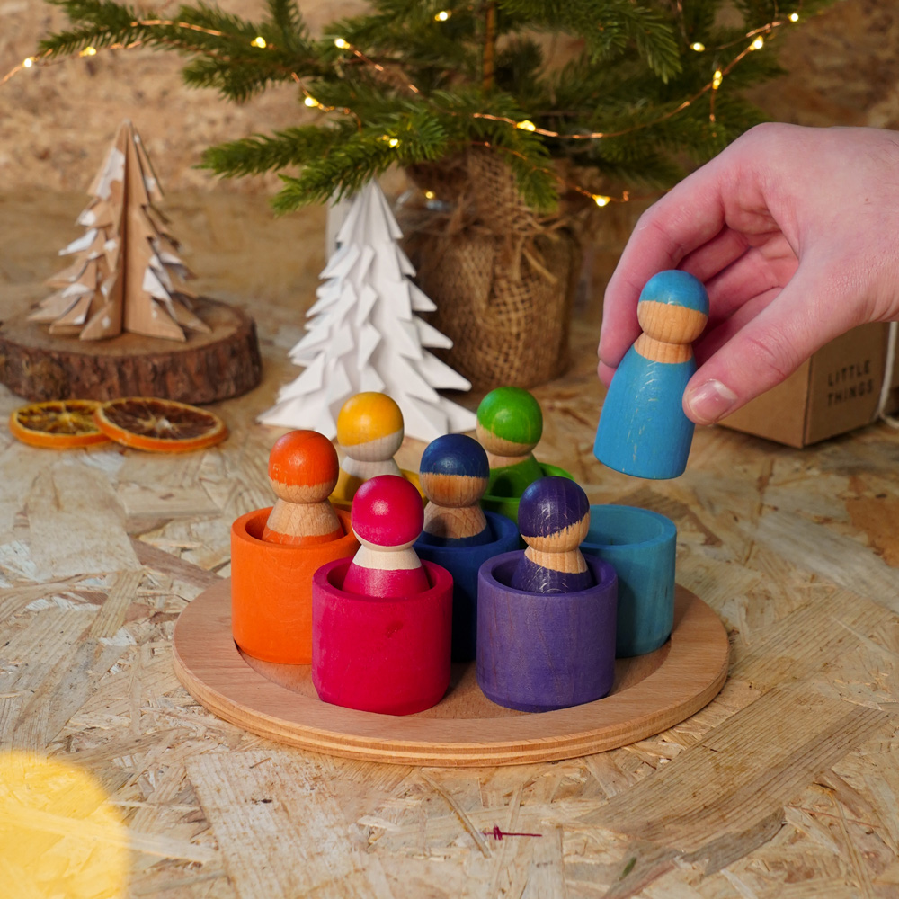 Grimm's wooden sustainable toys, 7 Friends in Bowls with Christmassy backdrop.