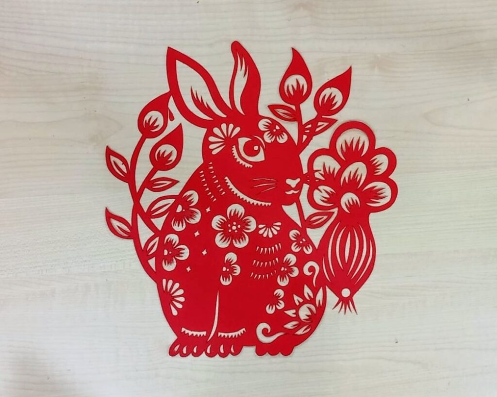 An intricate red paper cutting of a rabbit for Lunar New Year 