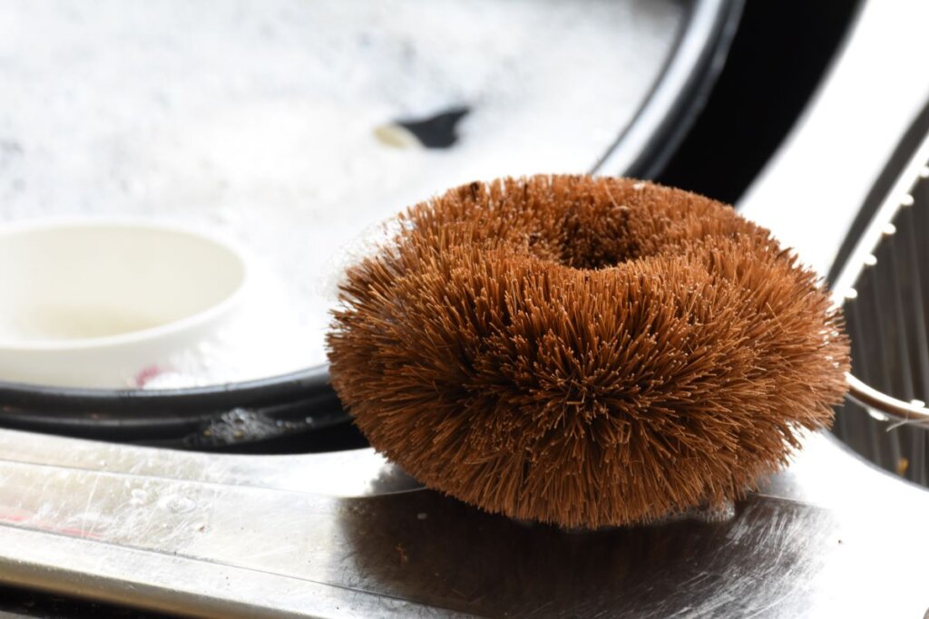 Eco Coconut plastic free kitchen scourer on the side of a sink